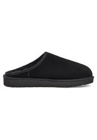 Sorte slip-on sko laget av myk tekstil, med rund tå, behagelig innersåle og en teksturert gummisåle for godt grep.