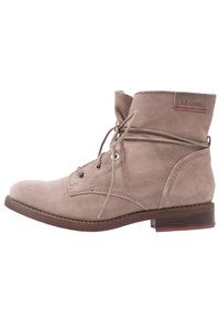 Beige suede ankle boot with round toe, lace-up design, metal eyelets, and a small stacked heel; features a logo patch on the side.