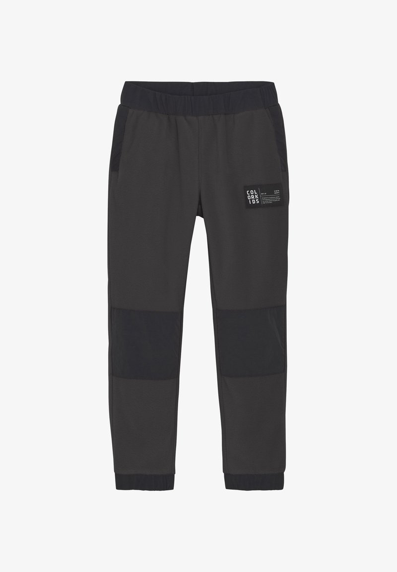 Pantalones de chándal grises con acentos de panel negro, cinturilla elástica y bolsillos laterales. Textura suave y diseño de pierna tapered.