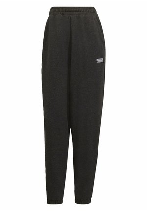 Pantaloni della tuta neri con elastico in vita, gambe affusolate e una piccola etichetta a logo bianco sul lato sinistro. Tessuto morbido e testurizzato.