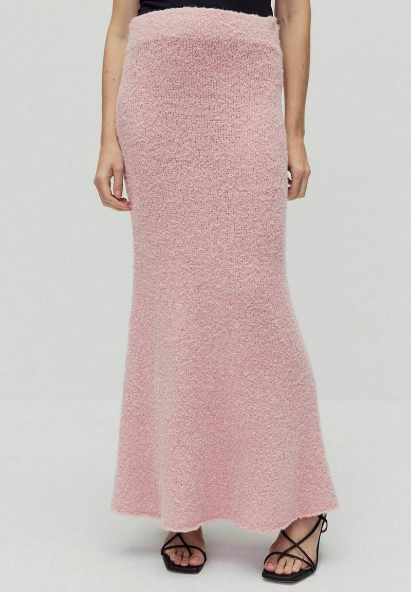 Roze gebreide maxi rok met een aansluitende taille en uitlopende zoom. Zachte, gestructureerde stof met een subtiel patroon en een enkellange snit.