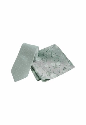 Green tie with small white polka dots and a matching pocket square featuring a floral design in similar hues and a smooth texture.