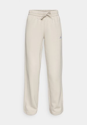 Beige joggings met een elastische tailleband en trekkoord, met een relaxed fit en een klein blauw logo aan de linkerkant. Zachte stofstructuur.
