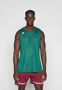 Green sleeveless athletic shirt with mesh texture and white accents, paired with maroon shorts featuring pink stripes.