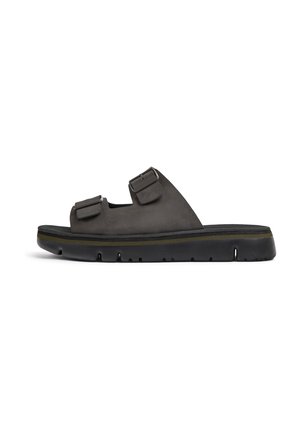 Black sandal made of suede with dual adjustable straps, a solid sole, and a subtle yellow accent along the edge. Minimalist design.