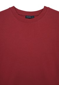 T-shirt in cotone rosso con scollo rotondo. Tessuto liscio e design semplice. Etichetta visibile con la scritta "CALLIOPE," taglia S.