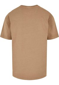 Brown T-shirt made of cotton, featuring a crew neck, short sleeves, and a straight hem. The texture is soft and the color is uniform.