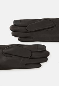 Black leather gloves with a smooth finish, featuring finger holes, a rounded overlay on the wrist, and a reinforced thumb area.