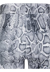 Legginsai su juodai baltu gy snake odos raštu, pagaminti iš lygaus, tampraus audinio, su aukštu juosmeniu ir be matomų detalių.