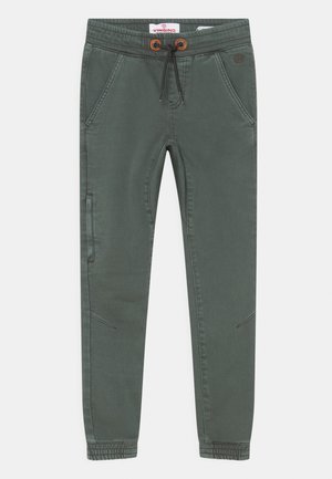 Pantalons de jogging verts en tissu doux, avec une taille élastique munie de cordon de serrage, des poches latérales et des poignets cintrés.
