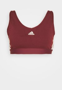 Burgunderröd sportbh i elastisk tyg med rund halsringning, breda band och vit Adidas-logotyp på framsidan. Har vita sidostråk.