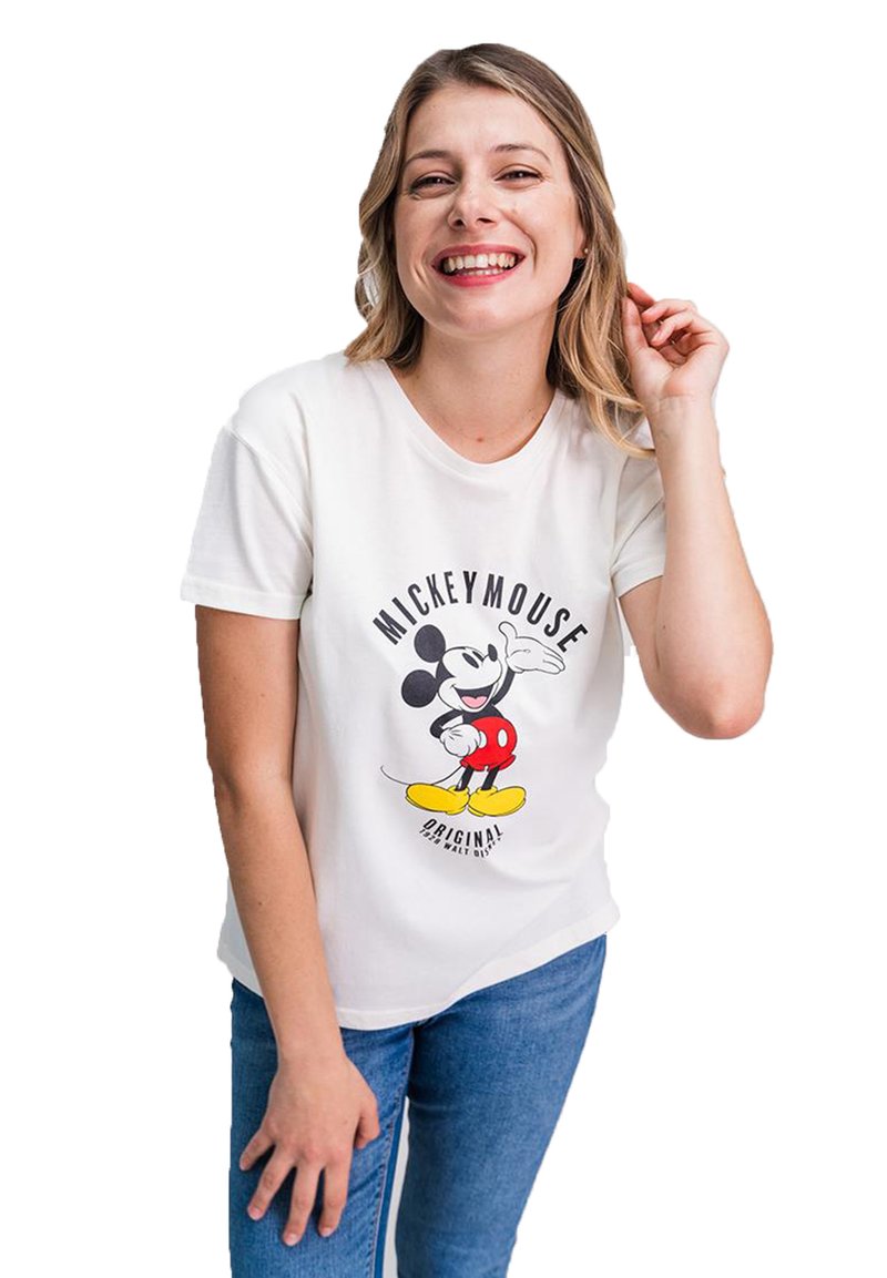 White cotton t-shirt featuring a graphic of Mickey Mouse in red shorts and yellow shoes. Model smiles, wearing blue jeans.