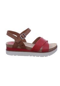 Red and brown leather sandal with cross straps, a cork base, and a white outsole. Features an adjustable ankle buckle and a textured footbed.