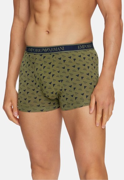 Green cotton boxer briefs featuring a repeating dark blue logo pattern, with a navy elastic waistband labeled "EMPORIO ARMANI."