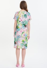 Blumenkleid mit kurzen Ärmeln, das eine Mischung aus Pink, Grün und Blau zeigt, aus leichtem Stoff und einem knielangen Schnitt.
