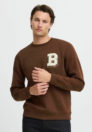 Brown sweatshirt made of soft fabric, featuring a cream-colored embroidered letter "B" on the chest and ribbed cuffs and hem.