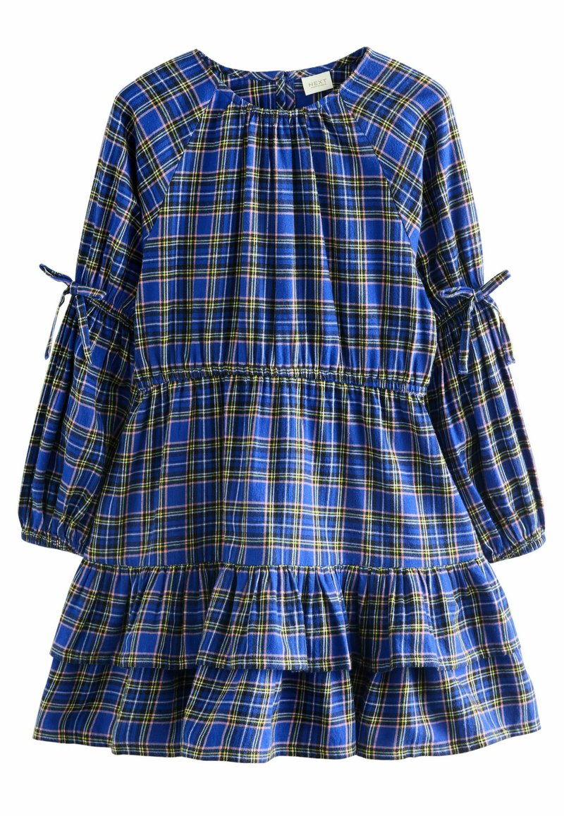 Robe à carreaux bleus avec des manches longues ornées de liens et un ourlet à volants en couches. Fabriquée en tissu doux avec des détails élastiques à la taille.