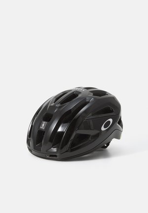Capacete de ciclismo preto com aberturas de ventilação, forma contornada e um logótipo circular proeminente. Feito de material suave e brilhante. Tamanho S.