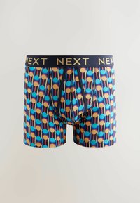 Shorts de boxeur à base bleu marine avec un motif géométrique vibrant comportant des cercles bleus, orange et roses. Complétés par une taille noire affichant "NEXT" en or.