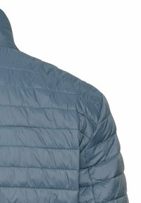 Gevoerde jas met een slim fit, in een lichtblauwe kleur, horizontale stiknaad en een opstaande kraag voor extra warmte.