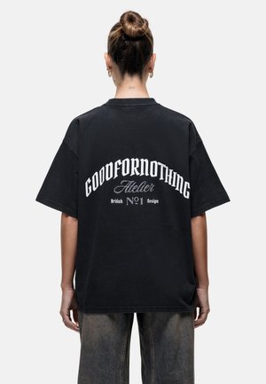 Zwarte oversized T-shirt met de opdruk "GOODFORNOTHING" in het wit op de achterkant, met afgeronde tekst, gemaakt van katoen en een relaxte pasvorm.