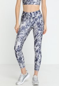 Leggings featuring a navy and white abstract pattern, made of stretchy fabric, with a high waistband and smooth texture.
