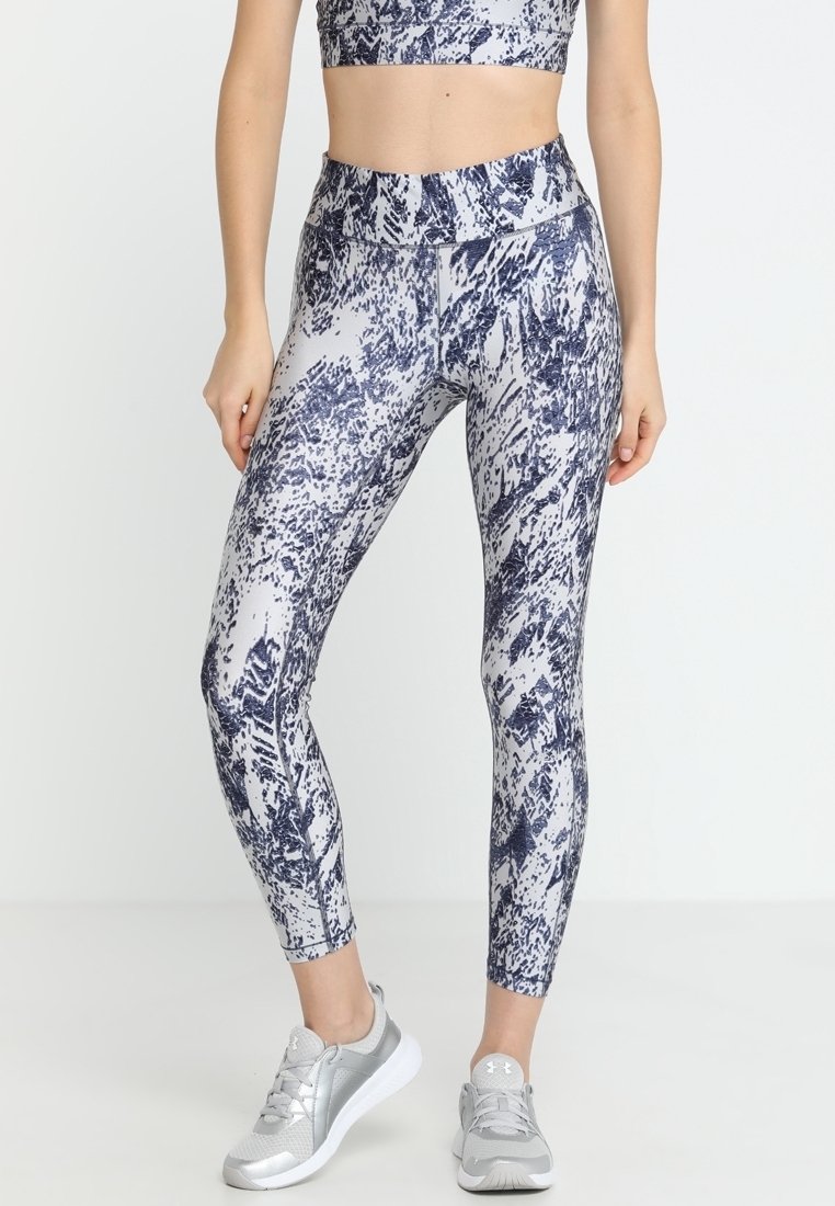 Leggings featuring a navy and white abstract pattern, made of stretchy fabric, with a high waistband and smooth texture.