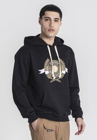 Sudadera negra de algodón, con un diseño gr�áfico dorado y acentos de laurel, un bolsillo delantero y cordones crema.