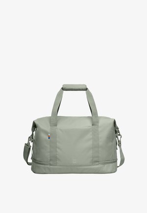 Bolsa de lona rectangular de color gris claro con dos asas, correa ajustable para el hombro y un compartimento inferior con cremallera.