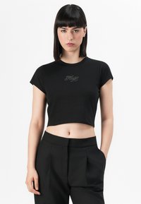 Black cropped t-shirt with short sleeves and a rounded neckline, featuring a crystal-embellished design in the center.