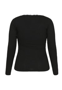 Black long-sleeve top made of ribbed material. Features a fitted design with a scalloped neckline and smooth texture.