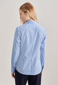 Camicia a quadri blu chiaro con un design aderente, maniche lunghe, orlo arrotondato e polsini con un bottone.