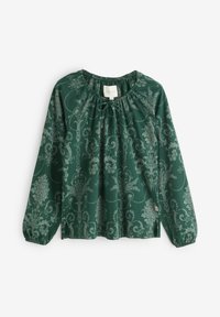 Tumši zaļa garām piedurknēm blūze ar ziedu rakstu gaiši pelēkā krāsā, savākta apkakle un elastīgas aproces brīvai piegulšanai.