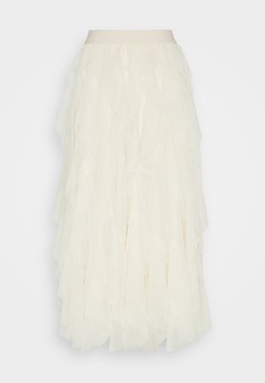 Jupe en tulle crème avec des volants superposés. Présente une taille lisse et une finition texturée et transparente. Tombe à mi-mollet.