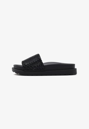 Black slide sandals with a wide strap featuring a textured, sparkling surface. Thick, flat sole with a ribbed edge for traction.