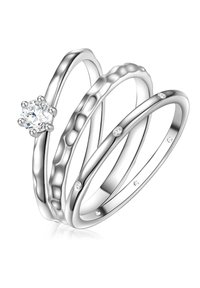 Három egymásba kapcsolódó gyűrű polírozott ezüstből. Az egyik középen egy kerek gyémánttal díszített; a többin kovácsolt textúra és finom drágakő díszítések találhatók.