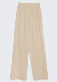 Beiga vida byxor med veckad design, mjukt tyg och elastisk midja. Har sidofickor. Mjuk textur.