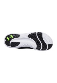 Black and white athletic shoe sole with textured grip, featuring a green Under Armour logo and patterned sections for traction.