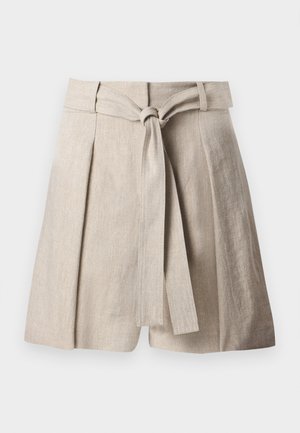 Jupe en lin beige à taille haute, avec des plis et une large ceinture en tissu nouée à l'avant.