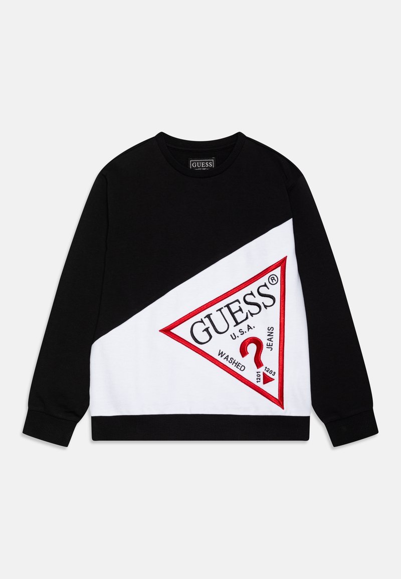 Felpa bicolore in bianco e nero con un logo triangolare rosso di Guess e la scritta "GUESS U.S.A. Washed Jeans" sulla parte anteriore.