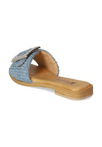 Light blue woven slide sandal with a textured upper, decorated with a silver buckle, and a smooth tan footbed and sole.