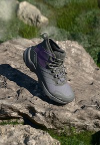 Lightweight hiking shoe in gray and purple, featuring a textured mesh upper, rubber sole, and padded collar for support.