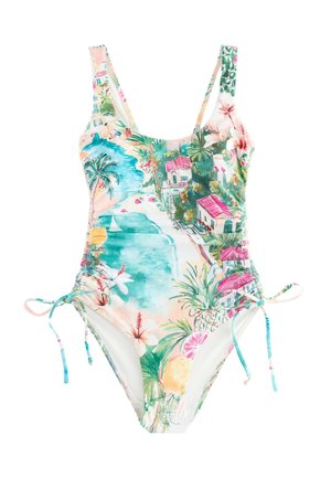 Dół od bikini w kwiaty z wiązaniem z boku i małymi złotymi zawieszkami w kształcie słońca, zwisającymi na opalonej skórze.