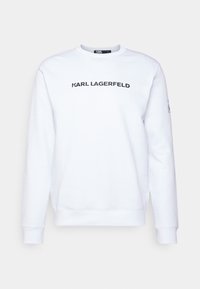 Sudadera de algodón blanco con cuello redondo, mangas largas y logo negro "KARL LAGERFELD" en el frente. Puños y dobladillo acanalados.