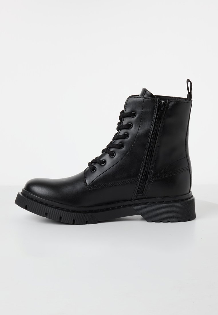 Bottes chevilles noires en cuir avec lacets à l'avant, fermeture éclair sur le côté et semelle texturée. Caractérisent un design robuste avec un talon plat.