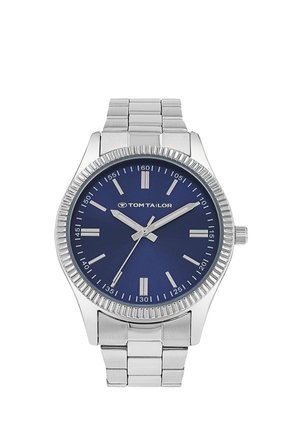 Silver metal wristwatch with blue dial, silver hour markers and hands, branded "Tom Tailor" on face, with linked strap band.