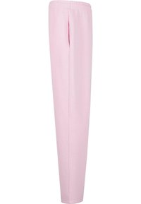 Lys rosa joggebukser laget av mykt materiale, med elastisk midjebånd og sidelommer, med en tapered design og uten synlige mønstre.