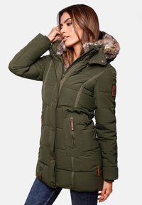 Green padded winter jacket with a faux fur-lined hood, zippered pockets, snap buttons, and quilted texture. Brown leather logo accent.
