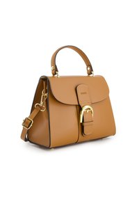 Tan leather handbag with a structured shape, gold hardware accents, top handle, detachable shoulder strap, and a flap closure with buckle detail.