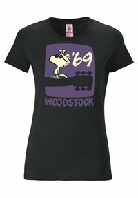 Black cotton t-shirt featuring a graphic of Woodstock the bird, wearing sunglasses, with text "'69" and "WOODSTOCK" in purple and yellow.